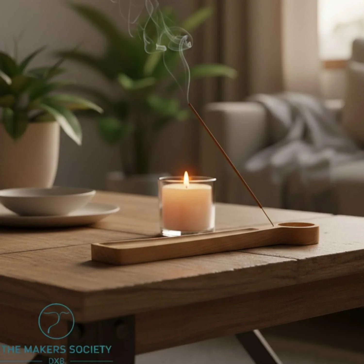Wooden incense and tealight holder on table with lit candle and smoke in cozy living room