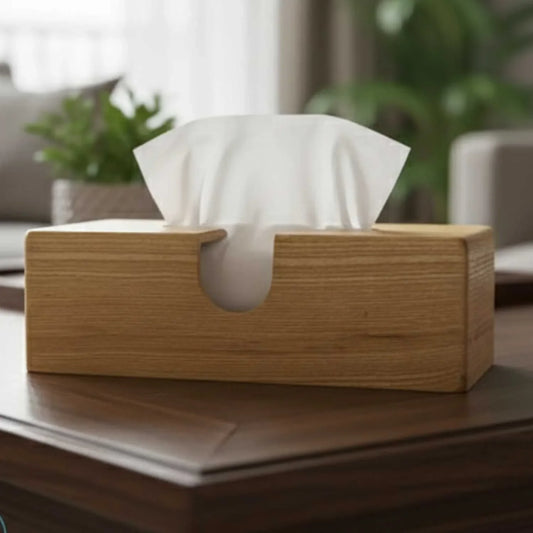Ash wood rectangular tissue box holder on a wooden table with plants in the background