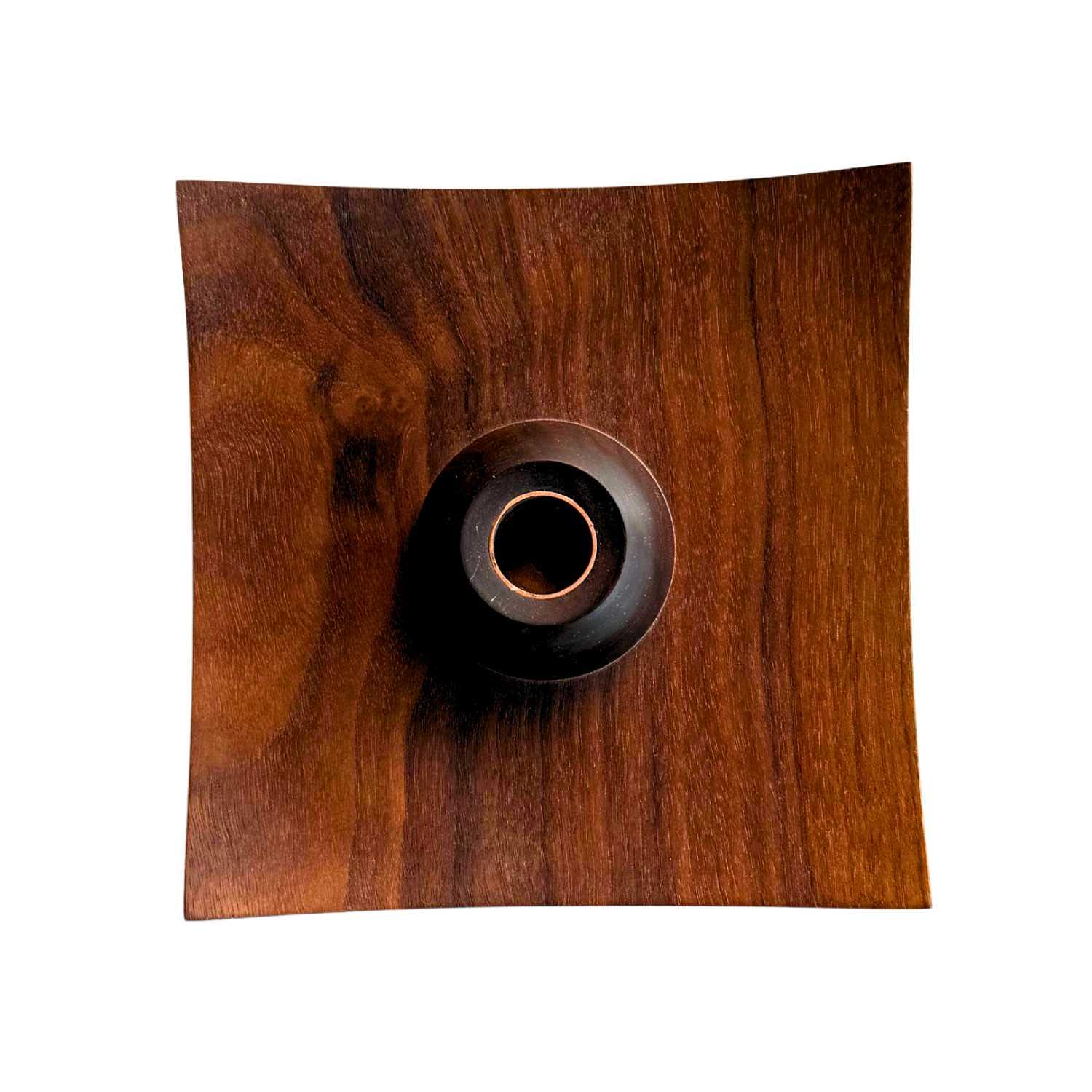 Handmade wooden square candleholder with bent edges and dark round center, natural wood grain