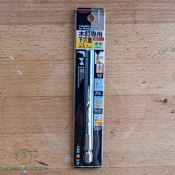 Kakuri tapered drill bit for wooden nails 4.7mm in retail packaging on wooden workbench