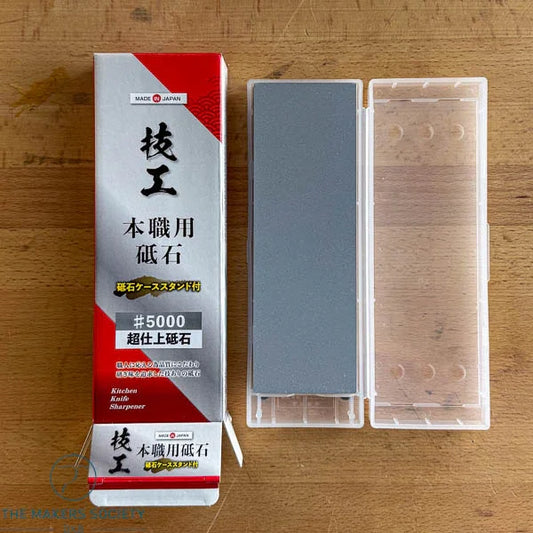Kakuri Gikoh professional grade Japanese whetstone #5000 with plastic case and box on wooden surface