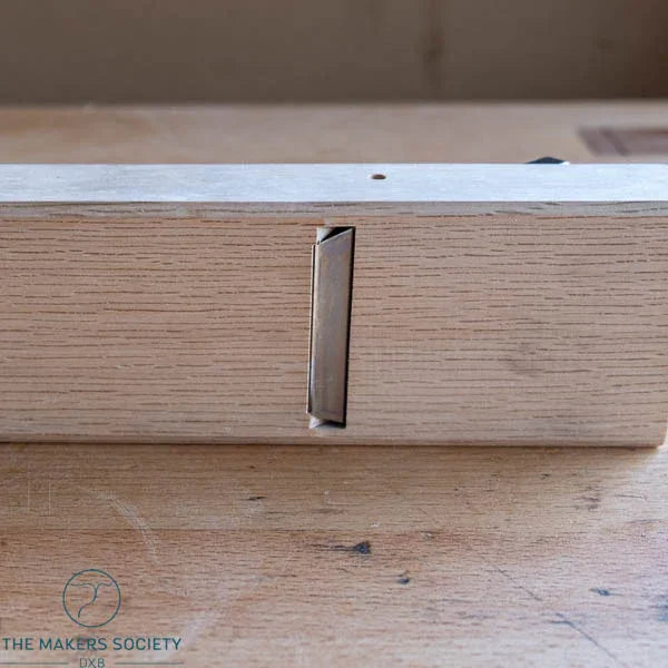 Bottom view of Kakuri 60mm white oak smoothing plane showing precision-set blade mouth