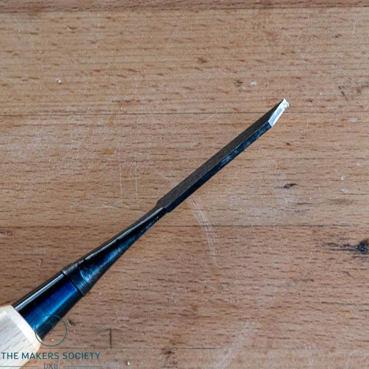 Close-up of Kakuri 3mm white steel chisel edge showing laminated blade and black ferrule