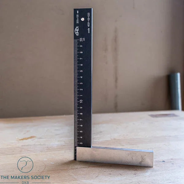 K-Met precision engineer’s square standing upright on wooden table showing black coated blade