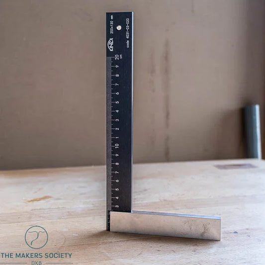 K-Met precision engineer’s square standing upright on wooden table showing black coated blade