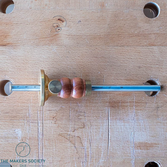 Full side view of the Luban marking gauge resting on a wooden workbench