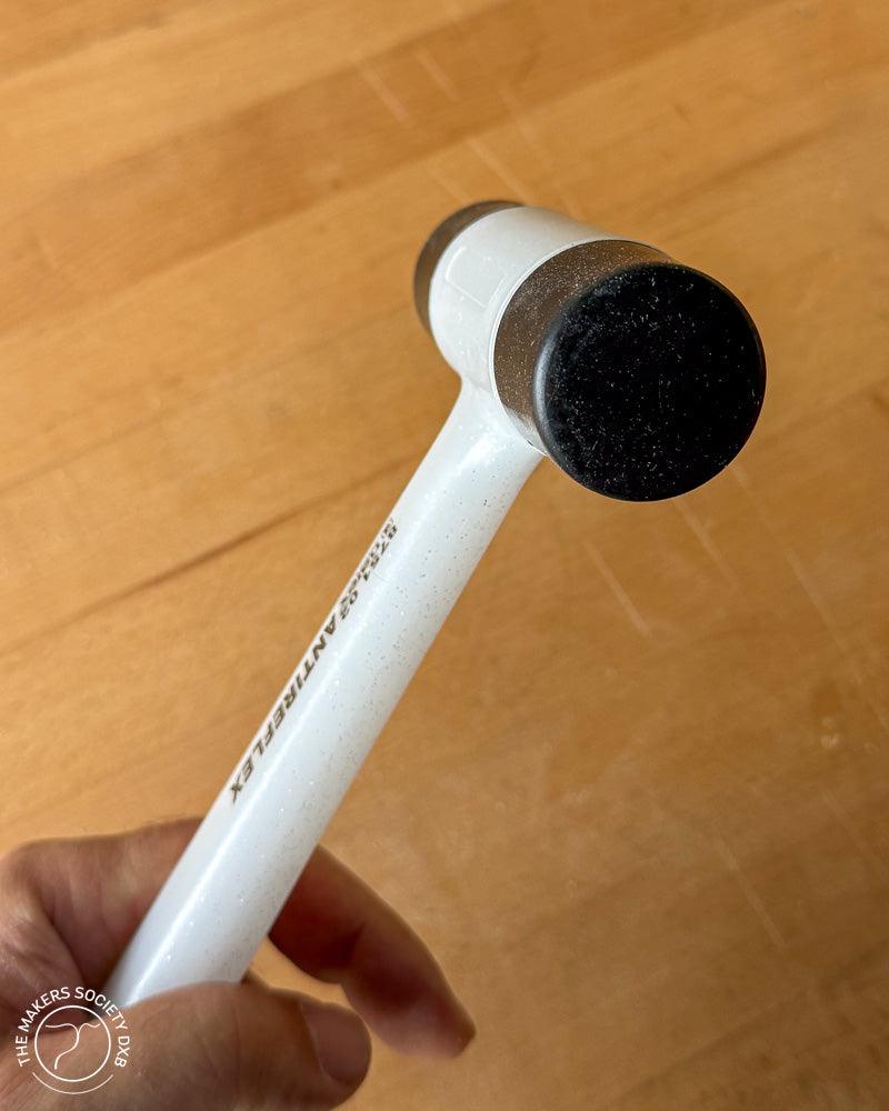 Narex bouncless mallet with plastic faces head view sitting on a woodworking bench and sold by The Makers Society Dubai