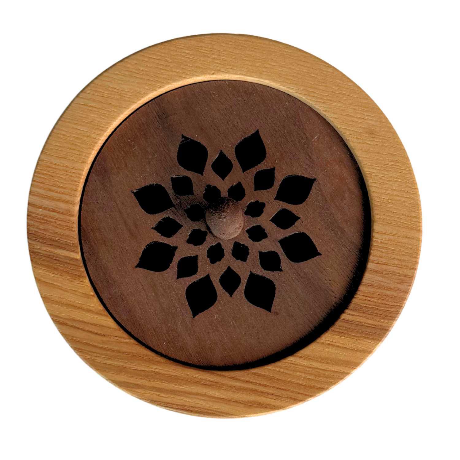 Wooden incense burner with floral design on a white background