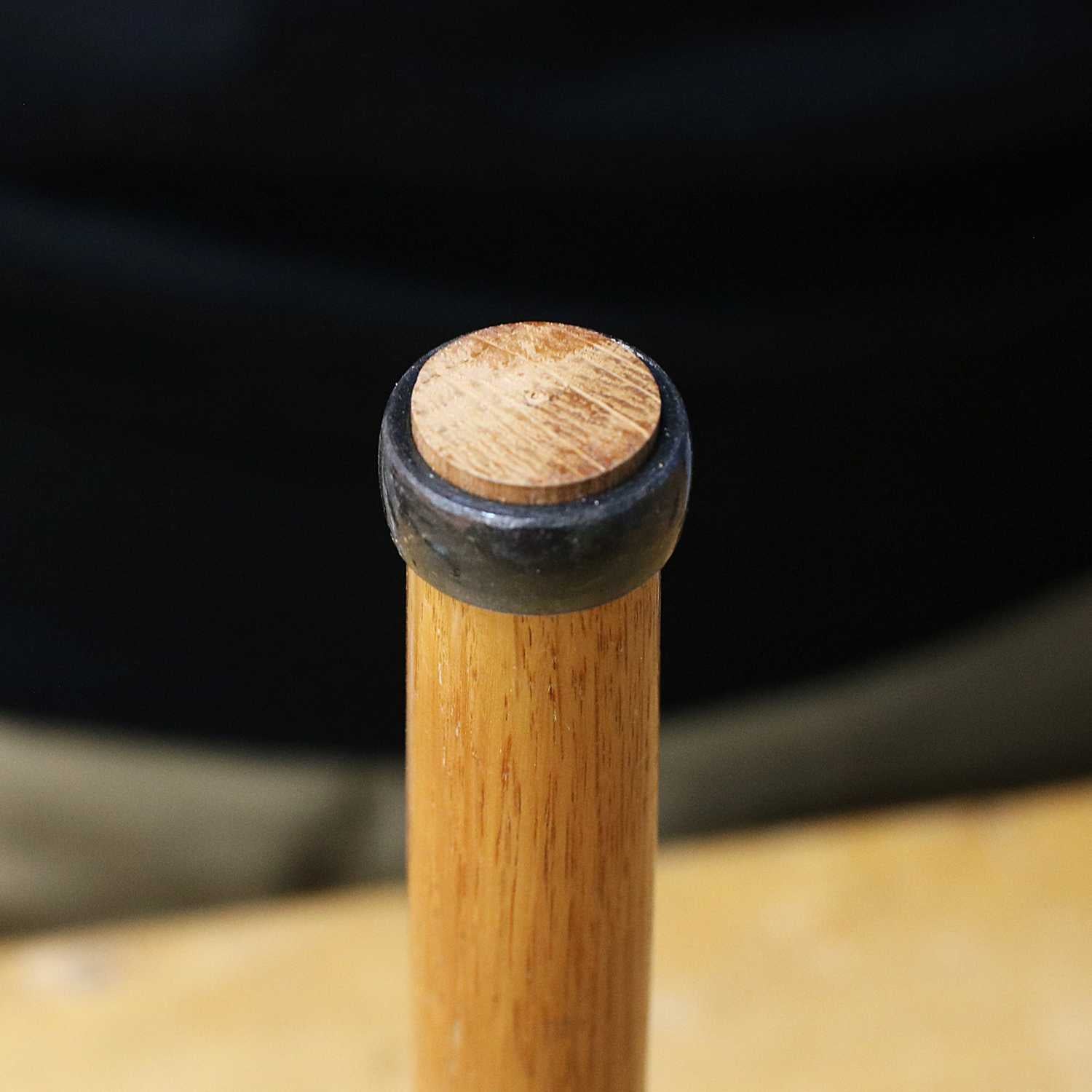 Close-up of Japanese chisel handle with metal hoop seated on the end grain of the wooden handle.