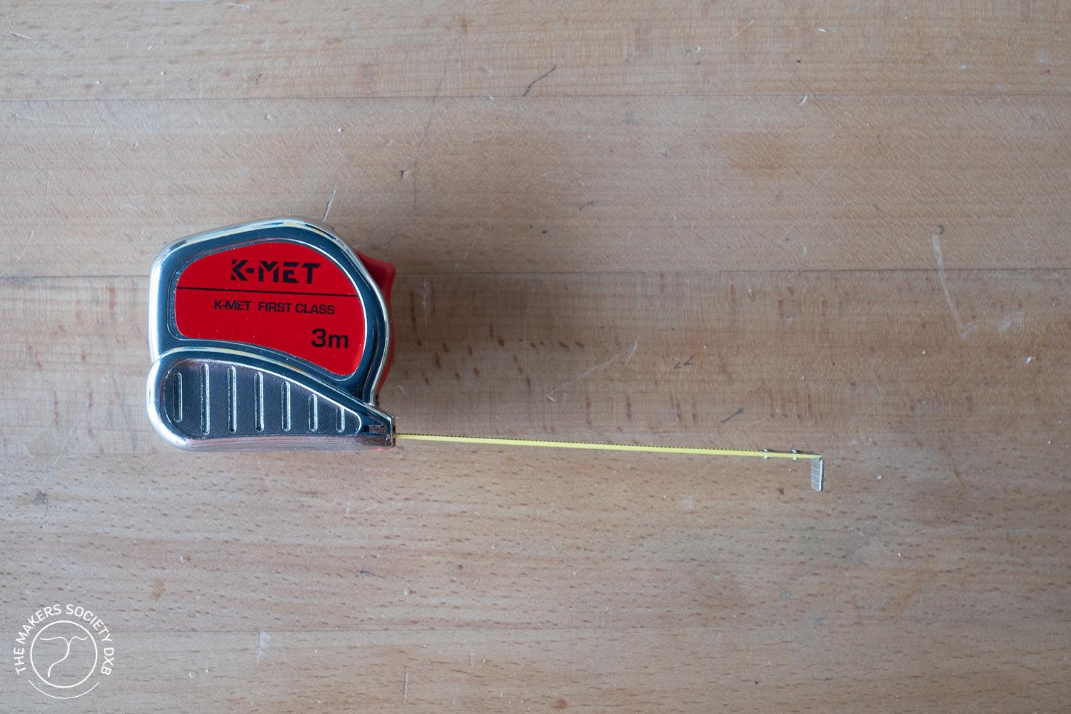 K-MET Tape Measure Festa 2m with tape extended. Compact, precision tape measure with a 2-meter length, durable case, and clear metric markings for accurate measurements, sold by The Makers Society Dubai.