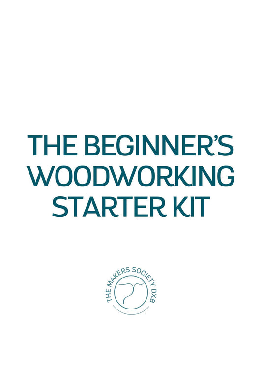White cover of The Beginner's Woodworking Starter Kit with teal text and The Makers Society DXB logo