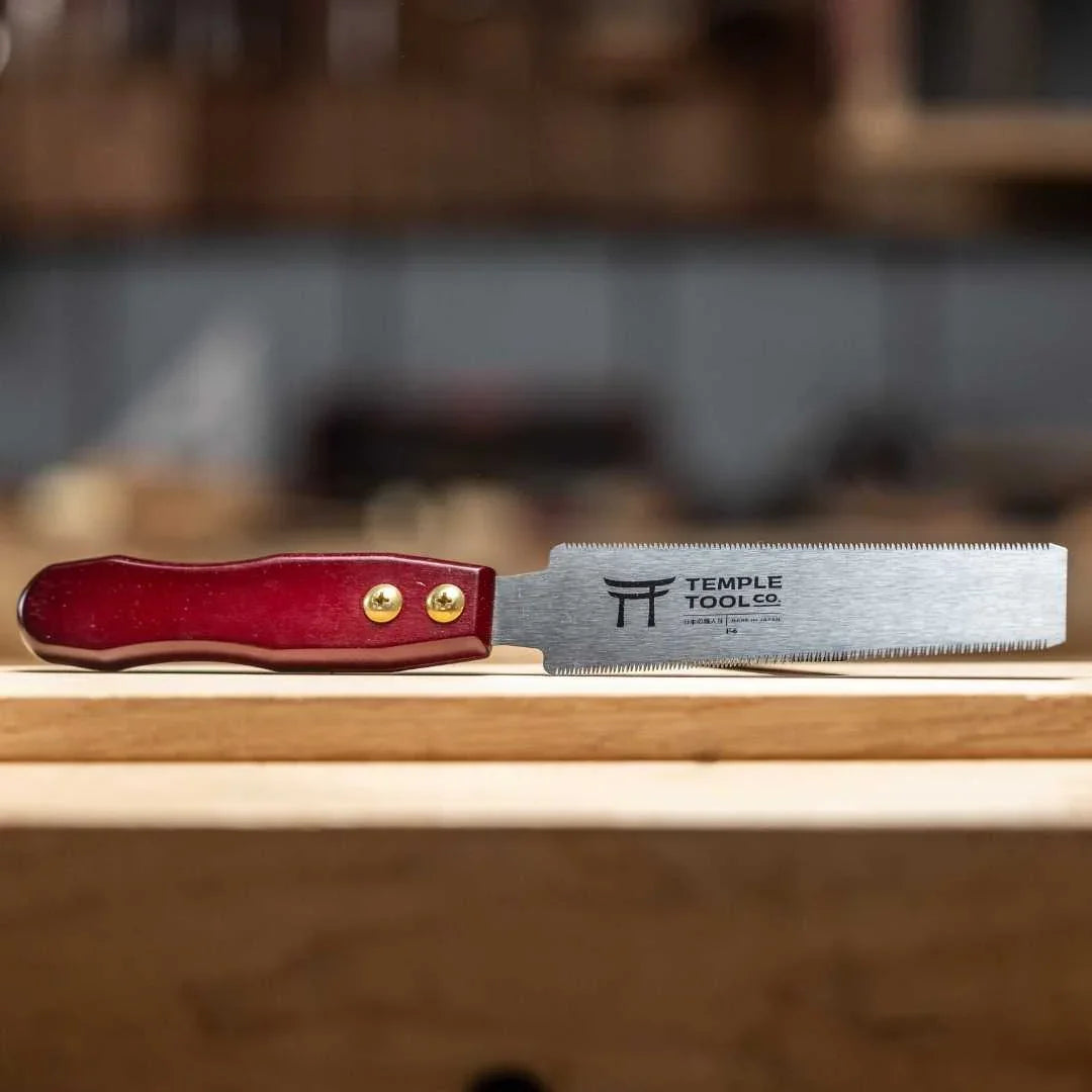 Temple Tool Co. 150mm flush cut pull saw with red wooden handle on wooden surface