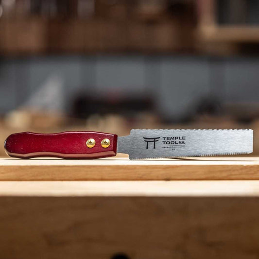 Temple Tool Co. 150mm flush cut pull saw with red wooden handle on wooden surface