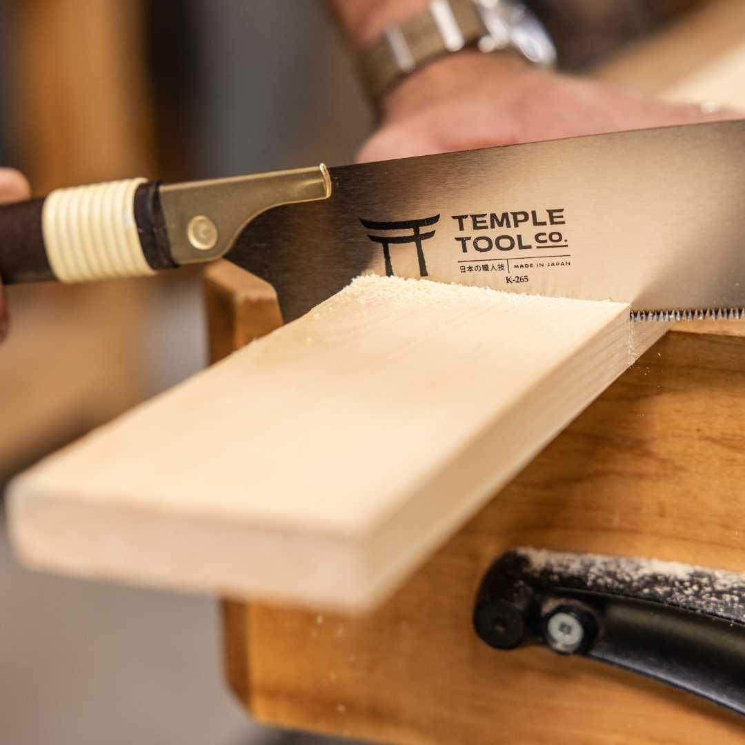 Temple Tool Co. Kataba pull saw cutting a wooden plank with fine teeth and wrapped handle