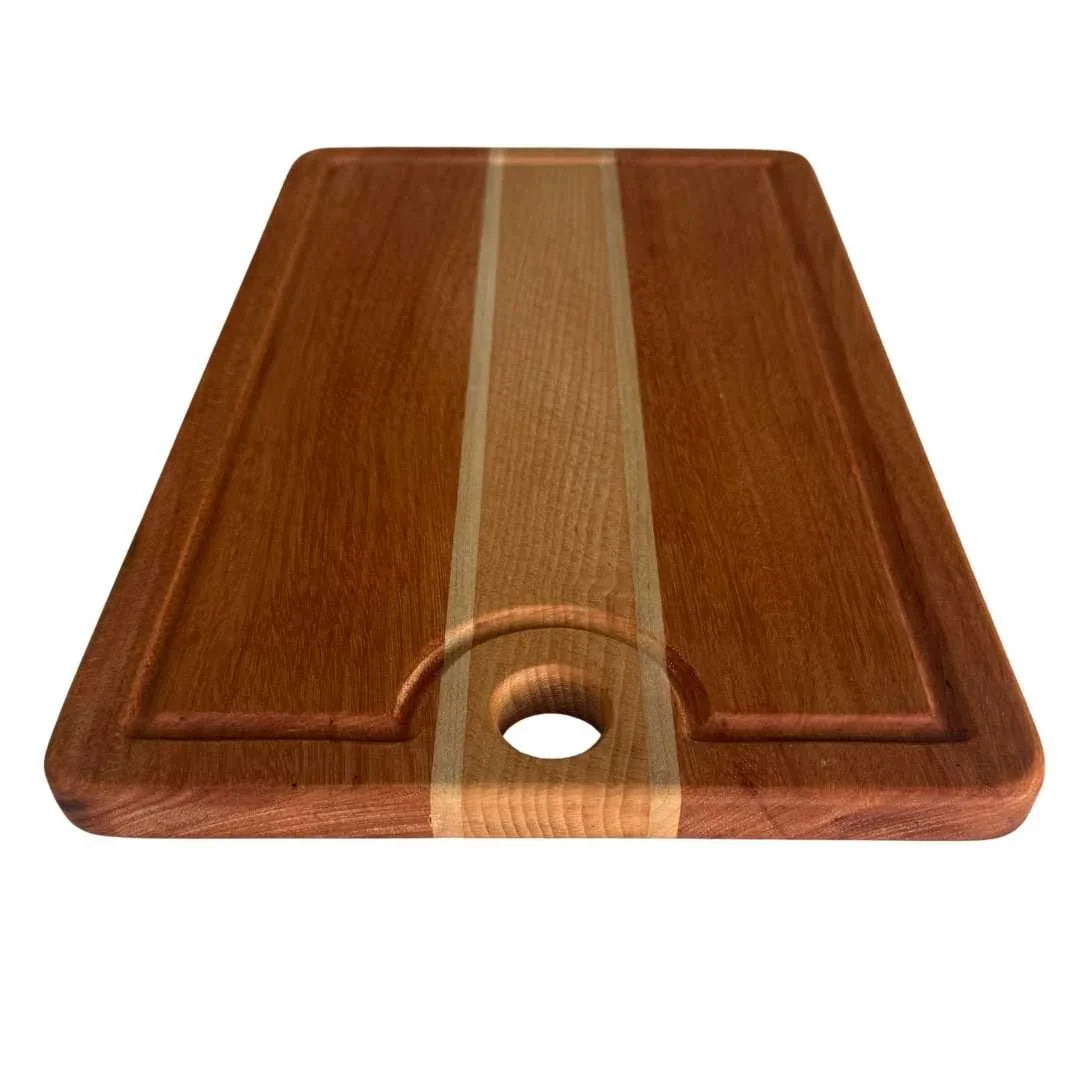 Wooden cutting board with juice groove and center handle hole, featuring two-tone wood grain
