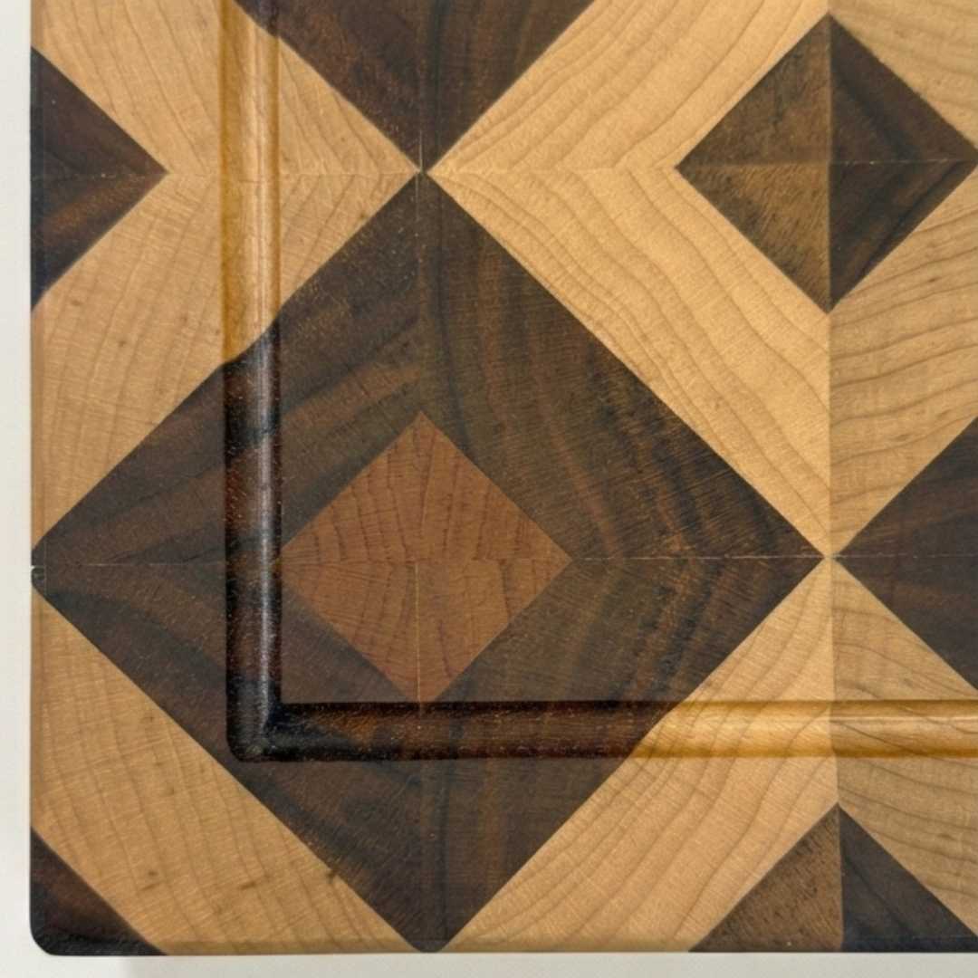 Close-up of geometric handmade wooden cutting board with diamond pattern detail