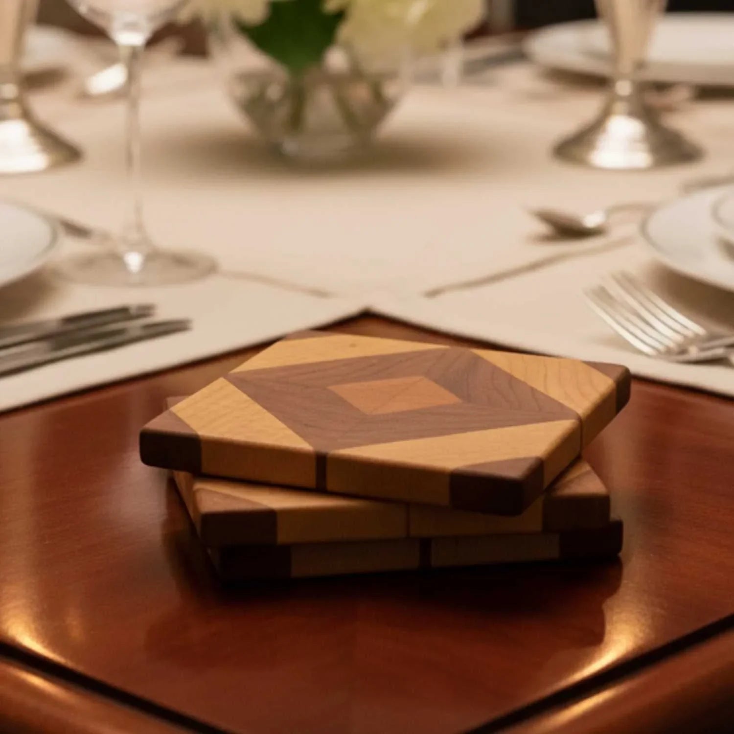 Stack of two wooden diamond-shaped coasters with geometric pattern on a polished table