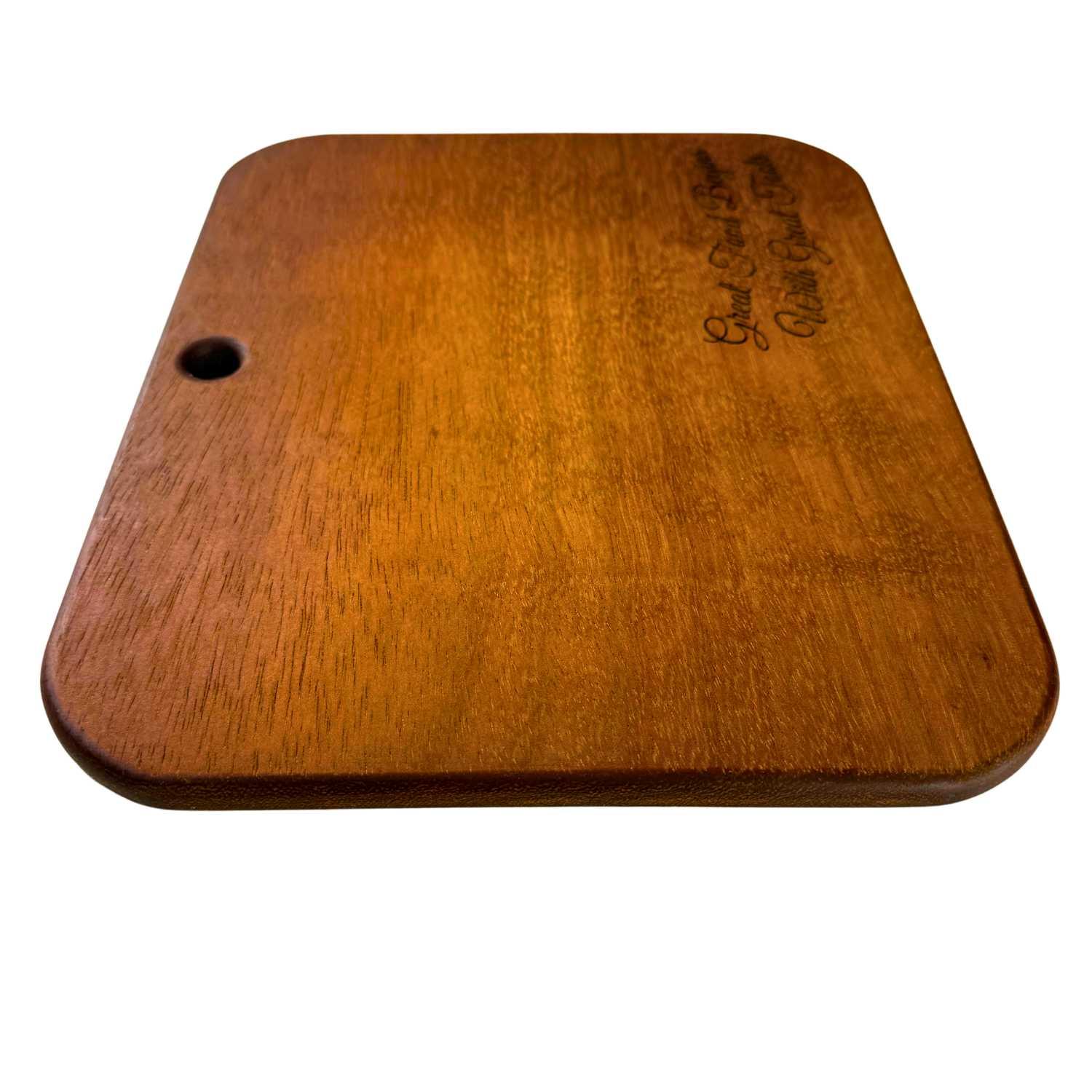 Rectangular Iroko wood serving board with rounded edges and a small hole for hanging