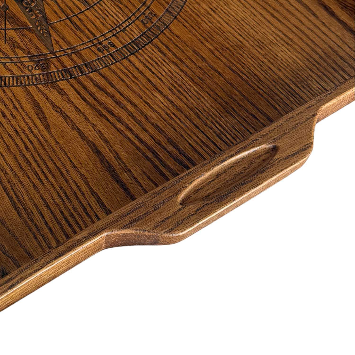 Close-up of a red oak rectangular serving tray with carved handle and compass design