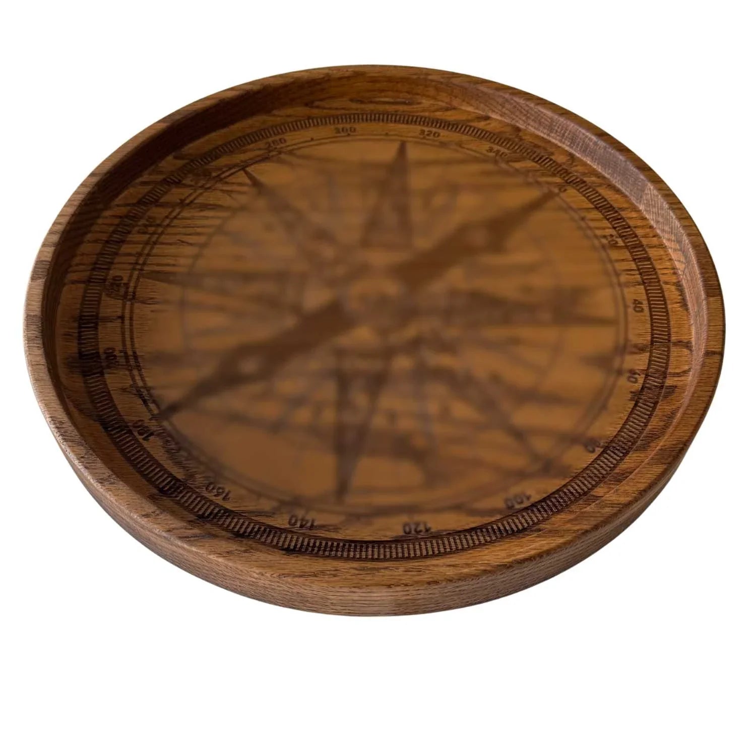 Round wooden serving tray in red oak with engraved compass design