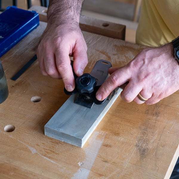 Setting up a honing guide for accurate chisel sharpening at The Makers Society woodworking studio.