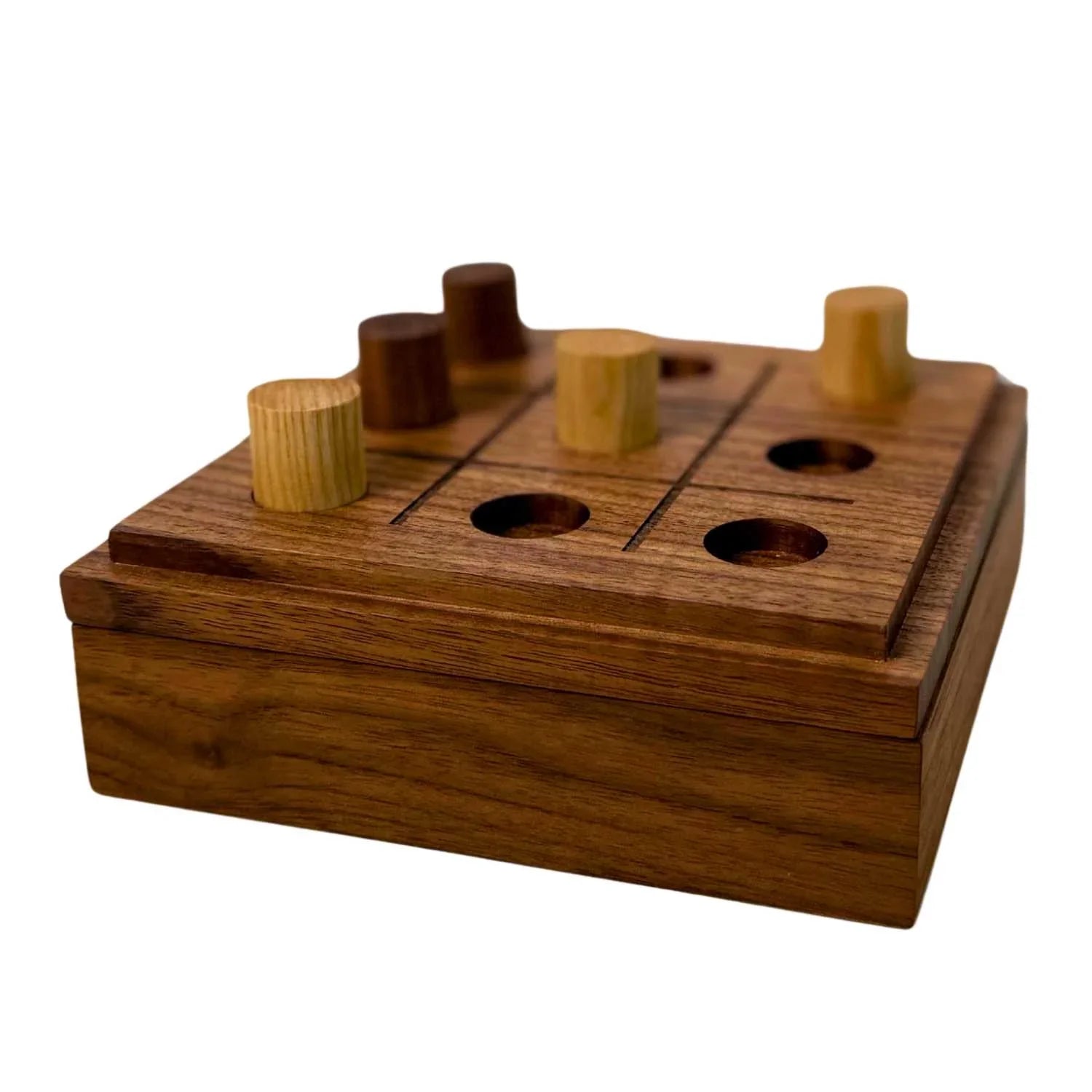 Wooden tic tac toe game board with cylindrical light and dark wooden pieces on storage box