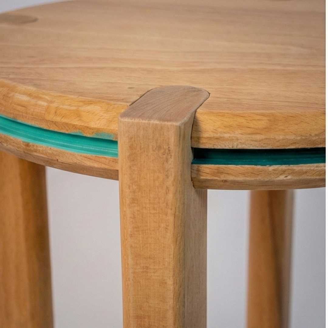 Close-up of a handmade wooden stool with teal accent from The Makers Society Shop